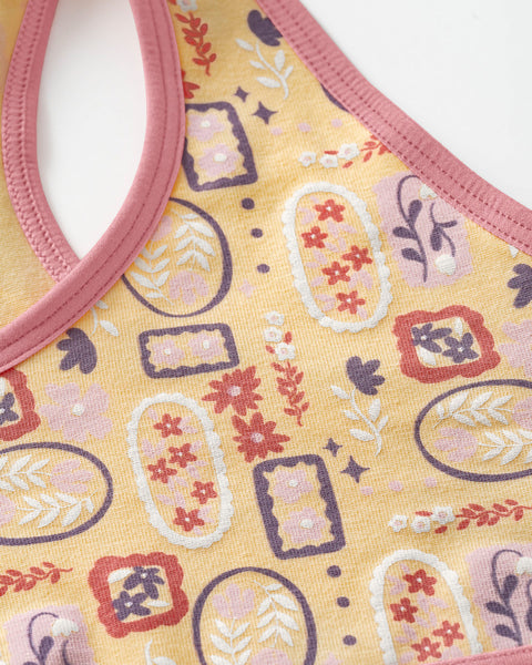 Top con espalda deportiva elaborado en algodón para niña#color_952-amarillo-estampado-flores